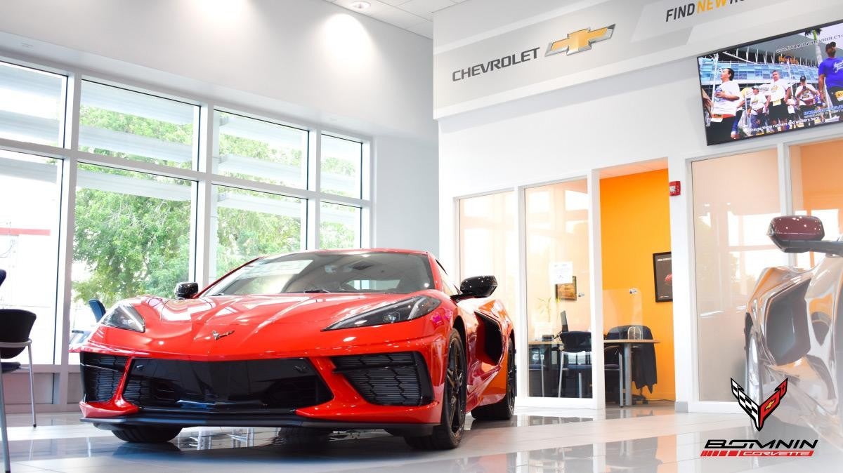red corvette in showroom