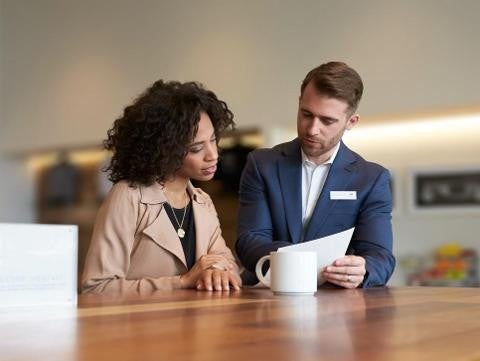 Bomnin Corvette in Miami FL sales representative and customer looking over paperwork together