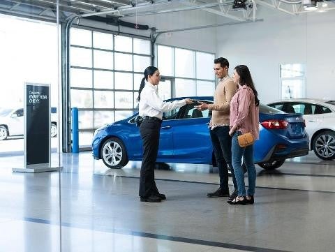 Bomnin Corvette in Miami FL employee handing keys to a man and woman