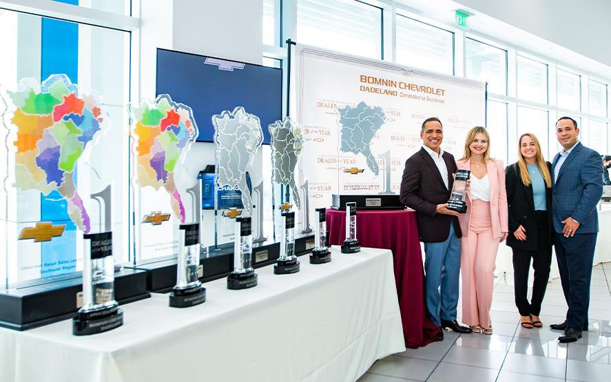 Bomnin Corvette in Miami FL staff standing in front of table of awards