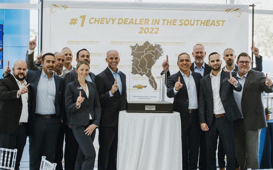 Bomnin Corvette in Miami FL staff standing in front of award sign